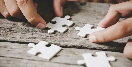 pieces-of-white-jigsaw-on-wood-P pieces-of-white-jigsaw-on-wood-P